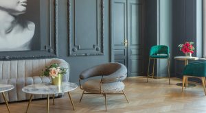 chic interior of the room in the Renaissance style of the 19th century with modern luxury furniture. walls of noble dark color are decorated with stucco and gilded frames, wooden parquet.